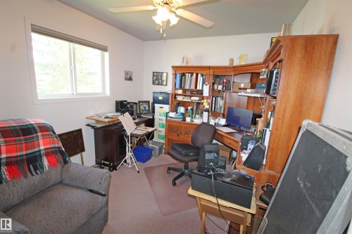 Second bedroom or office.  Carpeted room featuring a white-framed window, a ceiling fan with light fixture, and light-toned walls - 334 7001 Northview Drive, Wetaskiwin, AB - Indoor