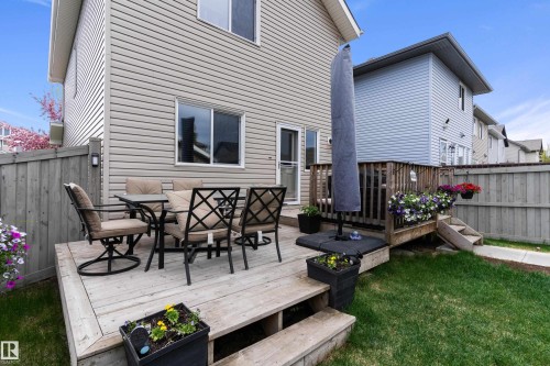 Multi-level wood deck featuring a railing system and steps to the lawn - 6822 Cardinal Link, Edmonton, AB 