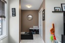 Entryway featuring light-toned wall paint, ceramic tile flooring, and a window with horizontal blinds - 6822 Cardinal Link, Edmonton, AB 