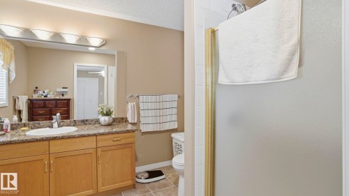 Bathroom featuring a light wood-finish vanity with a granite-style countertop and an integrated sink - 856 Graham Wynd, Edmonton, AB 