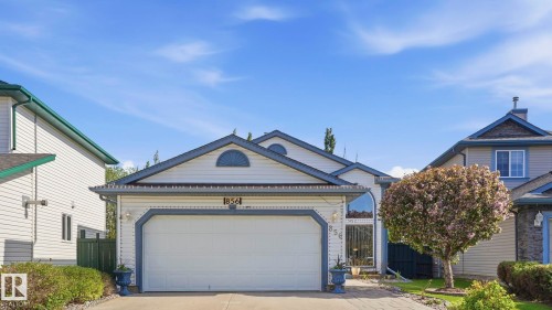 Single-story residence featuring a two-car garage with an arched trim detail - 856 Graham Wynd, Edmonton, AB 