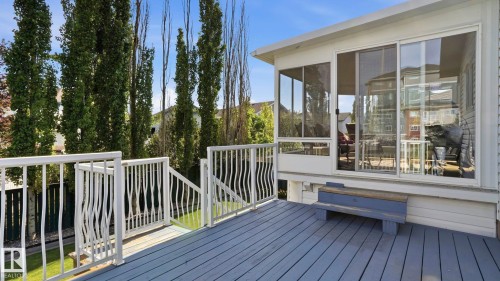 Expansive outdoor deck with painted wood flooring and white railings - 856 Graham Wynd, Edmonton, AB 