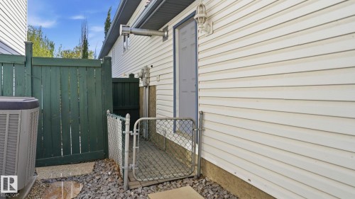 White horizontal siding with a light blue door - 856 Graham Wynd, Edmonton, AB 