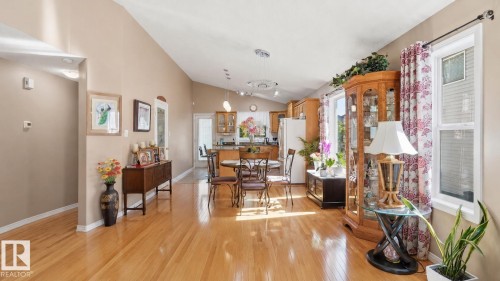 Spacious interior with wood-finish flooring, vaulted ceilings, and a light color palette - 856 Graham Wynd, Edmonton, AB 