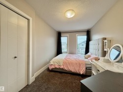 Room featuring neutral wall tones, textured carpet flooring, and a flush-mount ceiling light - 