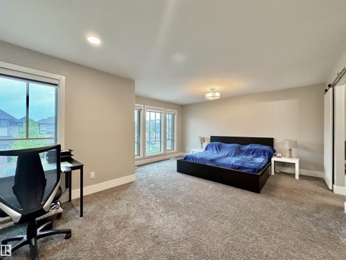 Spacious room with plush carpet flooring, recessed lighting, and a modern ceiling fixture - 3254 Allan Way, Edmonton, AB 