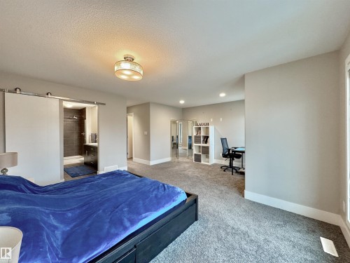 Spacious room featuring plush carpeting, light gray wall tones, and recessed lighting - 3254 Allan Way, Edmonton, AB 