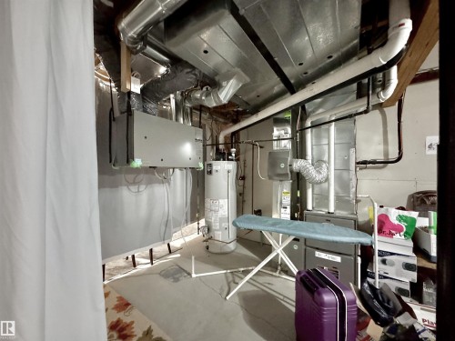 Basement utility area featuring exposed ductwork, water heater, and furnace system - 3254 Allan Way, Edmonton, AB 