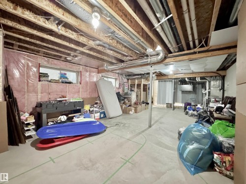 Unfinished basement with exposed ceiling joists and concrete flooring - 3254 Allan Way, Edmonton, AB 