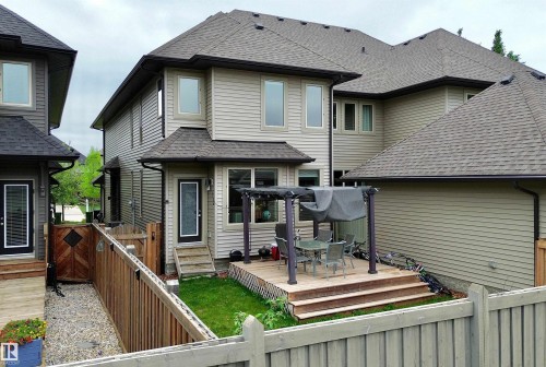 Rear exterior featuring a multi-level wood deck with pergola, manicured lawn, and wood privacy fencing - 3254 Allan Way, Edmonton, AB 