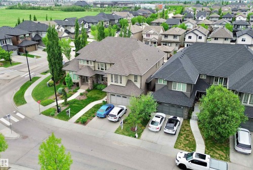 Expansive residential area featuring a curvilinear street layout, concrete sidewalks, and established landscaping - 3254 Allan Way, Edmonton, AB 