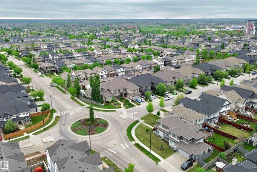 Expansive aerial perspective showcasing a residential development with numerous single-family homes - 3254 Allan Way, Edmonton, AB 