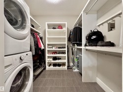 Laundry and storage area with stacked washer and dryer - 
