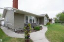 Ranch-style residence featuring horizontal siding and a red brick chimney - 52 Mohawk Crescent, Leduc, AB 