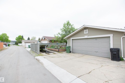 Detached garage with horizontal siding and a panel-style garage door - 52 Mohawk Crescent, Leduc, AB 