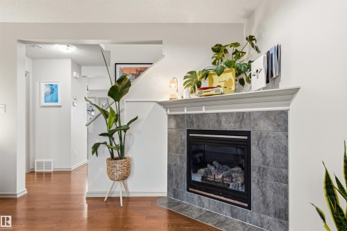 Fireplace with a tiled surround and hearth, featuring a classic mantel - 14807 141 Street, Edmonton, AB 