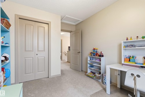 Carpeted interior room with a paneled bi-fold closet door - 14807 141 Street, Edmonton, AB 