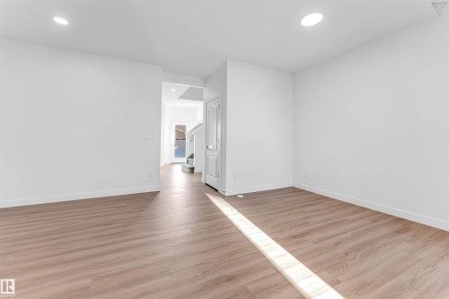 Spacious interior room with wood-finish flooring and recessed lighting - 1224 14 Avenue Nw, Edmonton, AB - Indoor Photo Showing Other Room