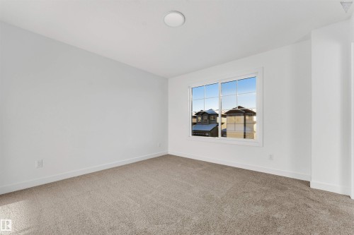 Bright room with neutral carpeting and white baseboards - 1224 14 Avenue Nw, Edmonton, AB - Indoor Photo Showing Other Room