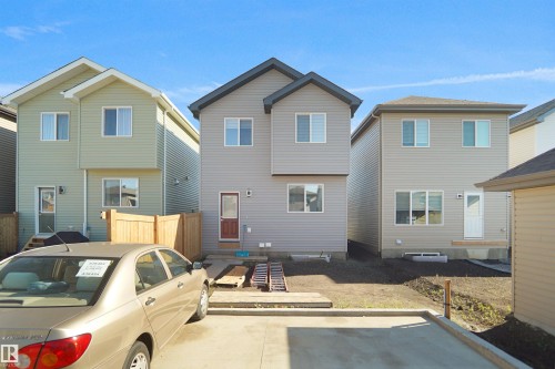 Two-story home with light gray siding exterior, featuring multiple windows for natural light - 1224 14 Avenue Nw, Edmonton, AB - Outdoor With Exterior
