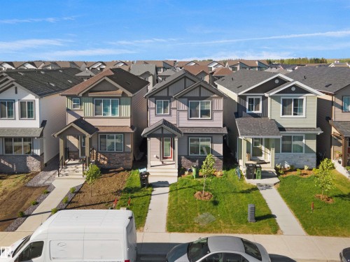Two-story residence featuring a covered front entry with white columns and dark railing - 1224 14 Avenue Nw, Edmonton, AB - Outdoor With Facade