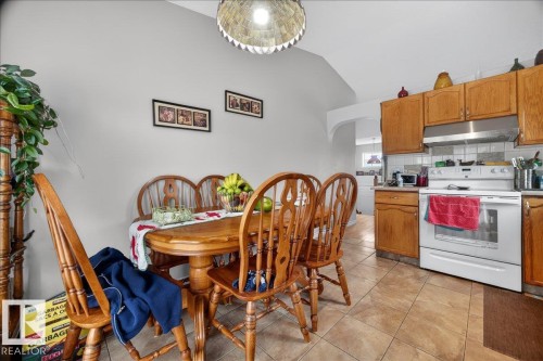 Bright dining area featuring vaulted ceilings and a distinctive light fixture - 5108 138A Avenue, Edmonton, AB 