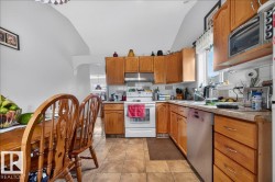 Kitchen featuring wood cabinetry, a white electric range, a stainless steel dishwasher, a single basin sink, and neutral-toned tiled flooring - 
