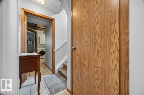 Panel door with a wood-grain finish and a polished chrome knob - 5108 138A Avenue, Edmonton, AB 