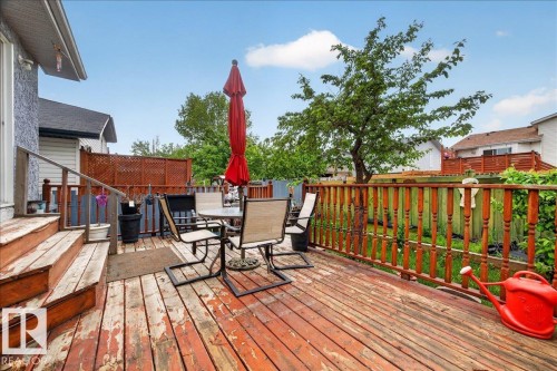 Elevated wood deck featuring stairs and a solid wood railing - 5108 138A Avenue, Edmonton, AB 