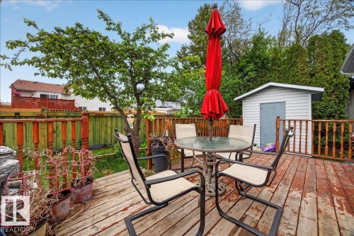 Expansive backyard deck featuring natural wood planks and a full wood privacy fence - 5108 138A Avenue, Edmonton, AB 