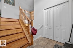 Hardwood staircase with natural wood balusters and handrail - 
