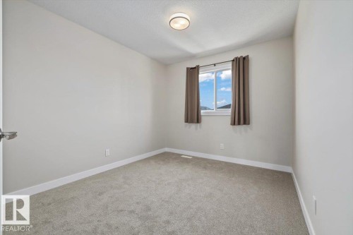 Neutral-toned walls complement the gray carpeting - 356 Pioneer Road, Spruce Grove, AB 