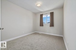 Neutral-toned walls complement the gray carpeting - 