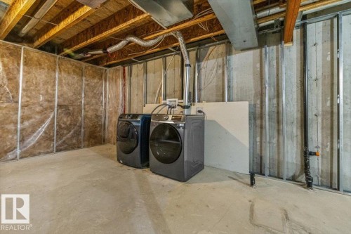 Unfinished basement space featuring exposed joists, concrete flooring, and insulated perimeter walls - 356 Pioneer Road, Spruce Grove, AB 