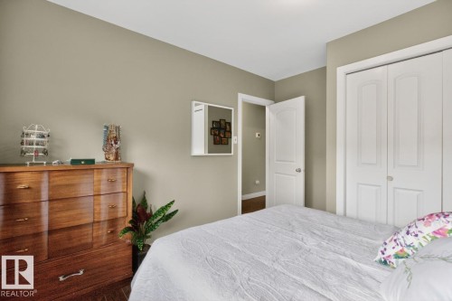 Bedroom featuring neutral wall paint, white trim, and wood-finish flooring - 9815 68 Avenue, Edmonton, AB - Indoor Photo Showing Bedroom