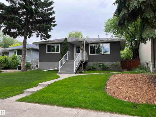 Contemporary exterior with dark gray stucco and a light gray foundation - 9815 68 Avenue, Edmonton, AB - Outdoor