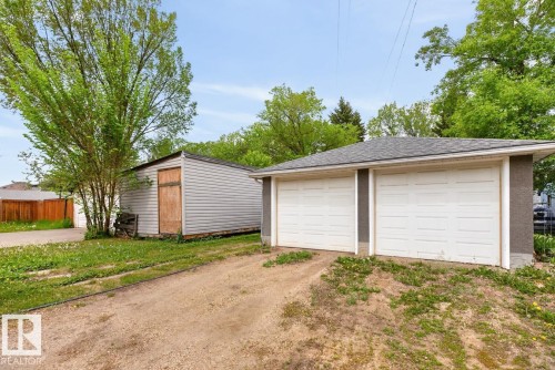 Detached two-car garage with white panel doors and a shingle roof - 9815 68 Avenue, Edmonton, AB - Outdoor With Exterior