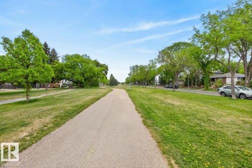 Paved multi-use path bordered by expansive green space and mature deciduous trees - 9815 68 Avenue, Edmonton, AB - Outdoor With View