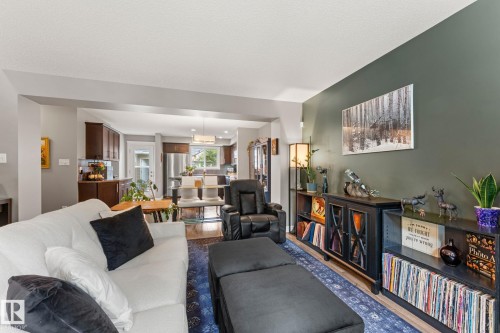 Open-concept living area with a distinct accent wall - 5813 63 Street, Beaumont, AB 