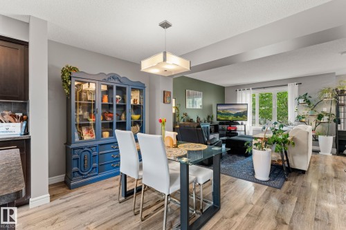 Open-concept living space with wood-finish flooring throughout - 5813 63 Street, Beaumont, AB 