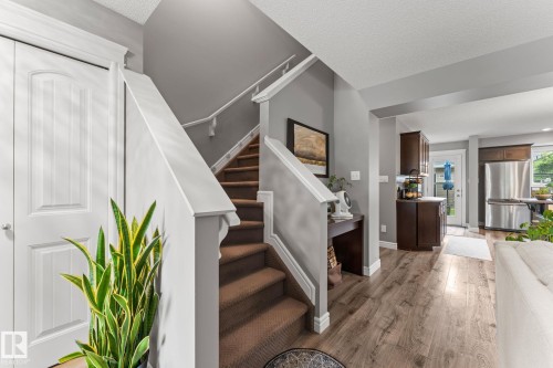 Carpeted staircase with white railings - 5813 63 Street, Beaumont, AB 