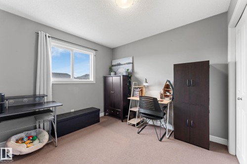 Room with a neutral color palette, featuring a light brown carpeted floor, light gray walls, and white trim - 5813 63 Street, Beaumont, AB 
