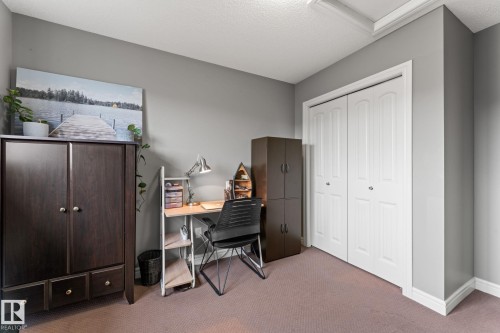 Neutral gray walls with white baseboards and crown molding - 5813 63 Street, Beaumont, AB 