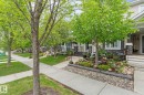 Exterior with cream siding, dark stone accent details, and white trim - 5813 63 Street, Beaumont, AB 