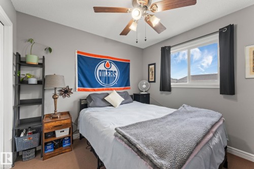 Neutral gray walls complement the window with black curtain panels - 5813 63 Street, Beaumont, AB 