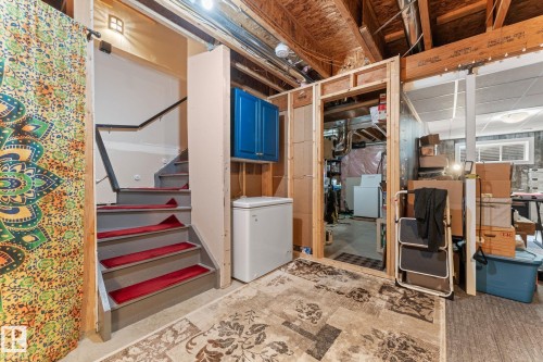 Staircase with gray treads and red risers - 5813 63 Street, Beaumont, AB 