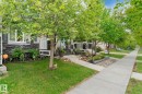 Property exterior featuring stacked stone accents, decorative window shutters, and a covered front entry - 5813 63 Street, Beaumont, AB 
