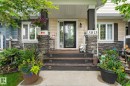 Welcoming entryway featuring a stone-clad porch column, wood-finish steps, and a glass-paneled front door - 5813 63 Street, Beaumont, AB 