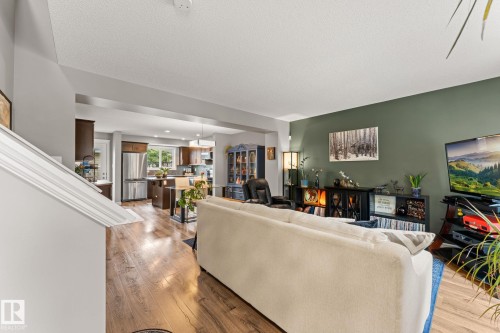 Open-concept living area with wood-finish flooring - 5813 63 Street, Beaumont, AB 
