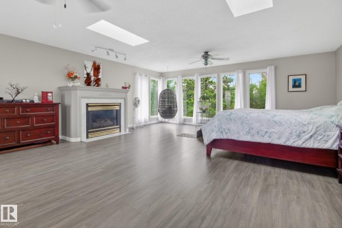 101 Hillside Place, Millet, AB - Indoor Photo Showing Bedroom With Fireplace